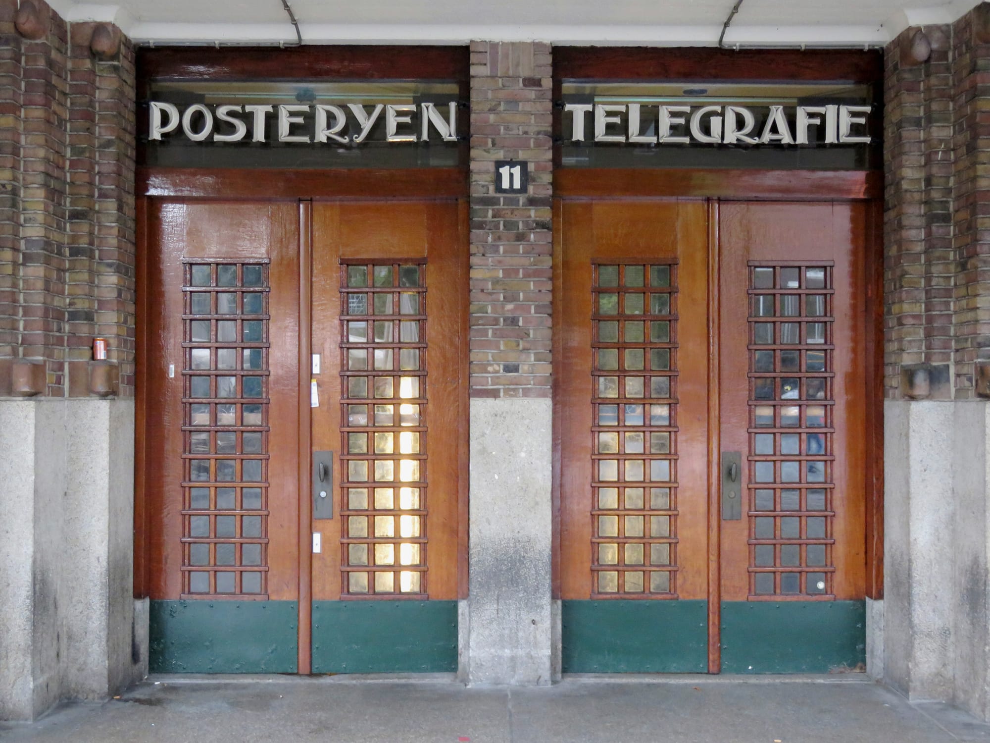 View of the entrance to the former Main Post Office (Neude 11) in Utrecht, with the texts 'POSTERYEN' and 'TELEGRAFIE' in metal letters above the doors. CC BY 4.0 Goosen, D.C.